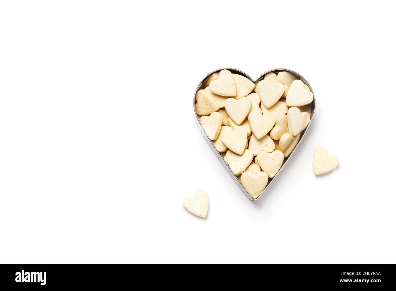 Heart-shaped little sweet cookies in heart form on white background, minimalistic saint valentine`s day greeting card Stock Photo
